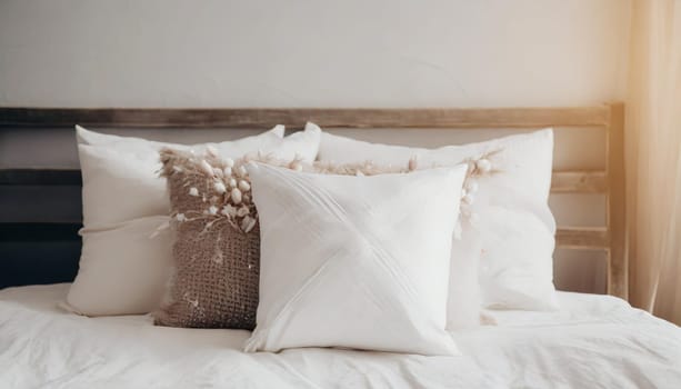Clean Bedding sheets and pillow on natural wall room background. White bedding and pillow in hotel room. White pillows on empty bed.
