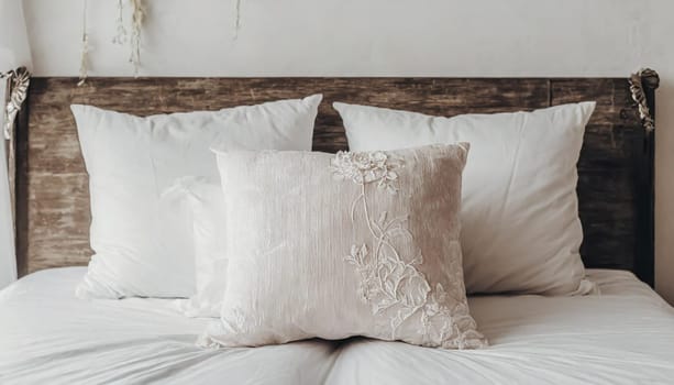 Clean Bedding sheets and pillow on natural wall room background. White bedding and pillow in hotel room. White pillows on empty bed.