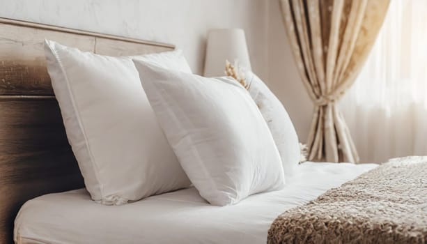 Clean Bedding sheets and pillow on natural wall room background. White bedding and pillow in hotel room. White pillows on empty bed.