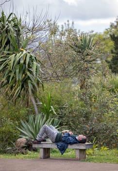 Funchal, Madeira, Portugal - April 23, 2018: Tourist tired from a day of sightseeing rests in Tropical Botanical Garden in Funchal on Madeira island, Portugal