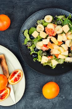 Fruit salad of red orange, apple, banana and herbs. Keto or paleo diet