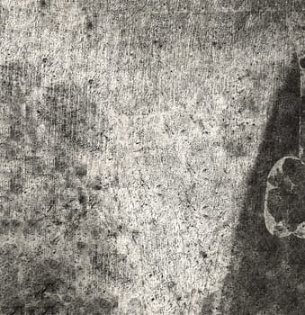 Old background texture of a black and gray wall with spots and roughness on the surface close-up