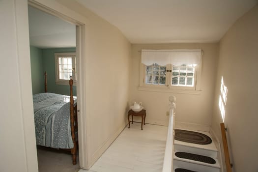 A hallway and bedroom in an old home.