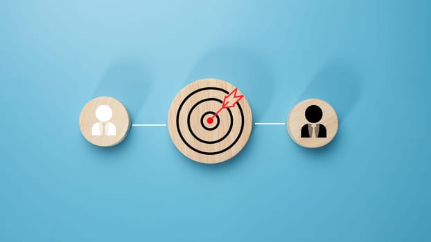 Circular wood with printed target icons and business symbols on light blue background, business goals and objectives concept, business competition, Customer relationship management concept.
