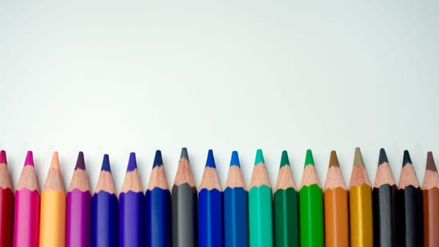 Set of colored pencils on a white background That is arranged in a bar graph, Color pencils on white background, Close up, seamless colored pencils row with wave on lower side, line pencils.