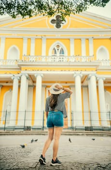 Travel girl looking at the Catholic church in Granada, Nicaragua. Tourism in Nicaragua, Tourist girl visiting the Granada cathedral