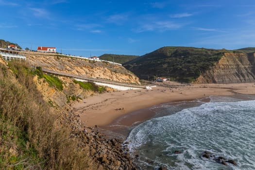 Sintra, Portugal: February 17, 2024: People at the beach of Magoito in a winter day, Sintra, Portugal