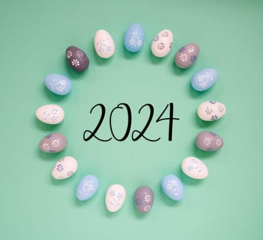 Flat Lay With Text 2024. Easter Egg Arrangement, Decoration And Ornament. Light Green Paper Background