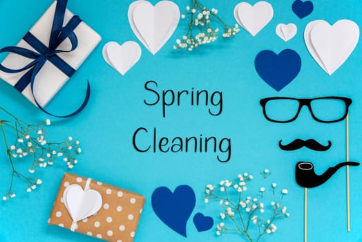 Flat Lay With English Text Spring Cleaning. Blue Accessories Like Presents, Hearts, Flowers And Male Decoration Like Mustache. Flat Lay With Turquoise Paper Background.