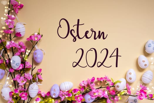 German Text Ostern 2024 Means Easter 2024 On Beige Background. Pink And Purple, Shiny And Bright Spring Flower Arrangement With Easter Egg Decoration.