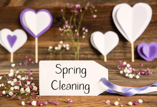 Label With English Text Spring Cleaning. Purple And Lilac Decoration And Spring Flower Arrangement. Heart Symbols With Wooden Background.