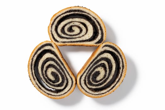 Delight in a three of German poppy seed cake slices, each offering a moist texture and a delightful poppy seed filling, elegantly presented against a pristine white backdrop.