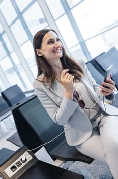 businesswoman doing a few quick work related calls while waiting for check-in at the gate of airport