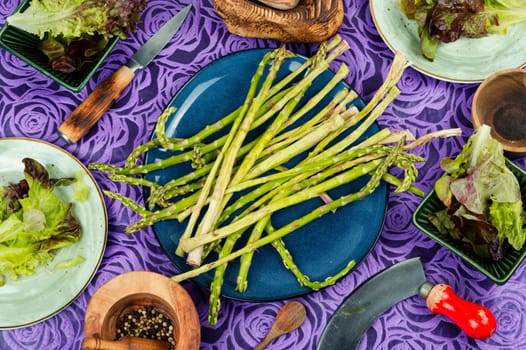 Uncooked raw and fresh asparagus on the kitchen table.