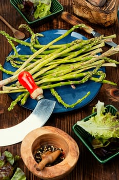 Uncooked raw and fresh asparagus on the kitchen table.