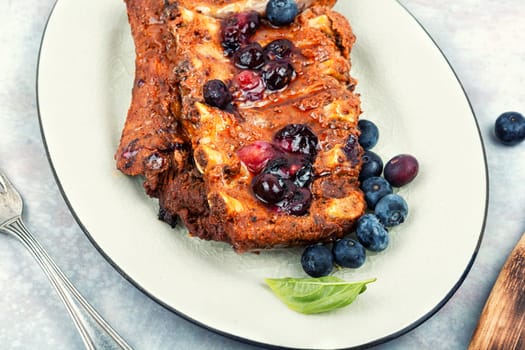 Fried pork ribs with blueberry marinade or sauce.