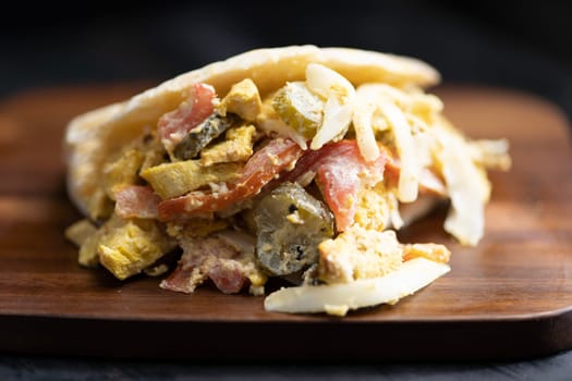 close up of greek chicken pita sandwich