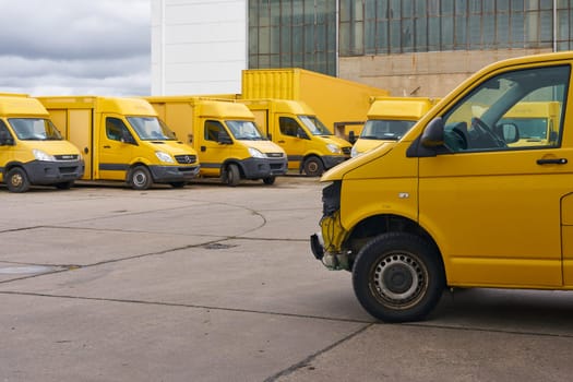 Discarded DHL vehicles that are no longer roadworthy in the yard of a car recycler in Magdeburg, Germany