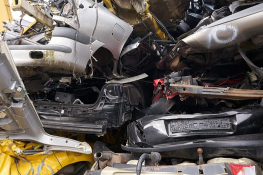 Cars in a scrap yard of a car recycling company in an industrial area in Magdeburg in Germany