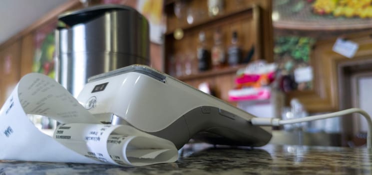 Payment terminal over bar counter. Focus numeric keyboard