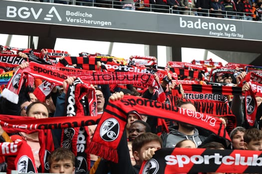 Atmosphere in the Freiburg fan curve at the Badnerlied,the fans celebrate with fan scarves and singing and heat up the atmosphere at the game of the 1st FBL: 23-24: 26. Sptg. SC Freiburg - Bayer 04 Leverkusen  DFL REGULATIONS PROHIBIT ANY USE OF PHOTOGRAPHS AS IMAGE SEQUENCES AND/OR QUASI-VIDEONann  Photo: Joachim Hahne/johapress
