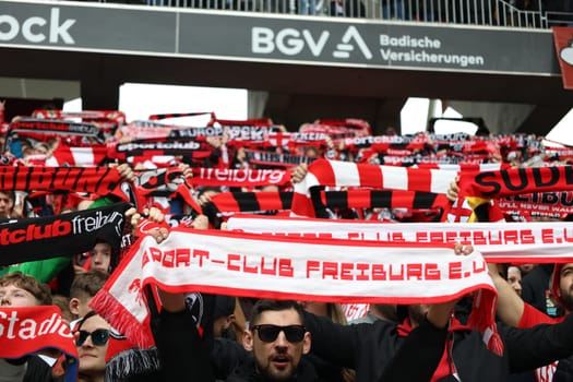 Atmosphere in the Freiburg fan curve at the Badnerlied,the fans celebrate with fan scarves and singing and heat up the atmosphere at the game of the 1st FBL: 23-24: 26. Sptg. SC Freiburg - Bayer 04 Leverkusen  DFL REGULATIONS PROHIBIT ANY USE OF PHOTOGRAPHS AS IMAGE SEQUENCES AND/OR QUASI-VIDEONann  Photo: Joachim Hahne/johapress