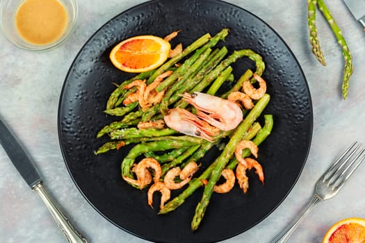 Delicious boiled shrimp with green asparagus. Seafood menu.