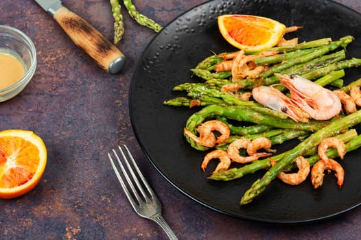 Delicious boiled shrimp with green asparagus. Seafood menu.