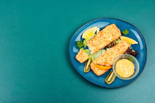 Pollock fillet roasted in bread crumbs and with kiwi. Fish. Space for text.