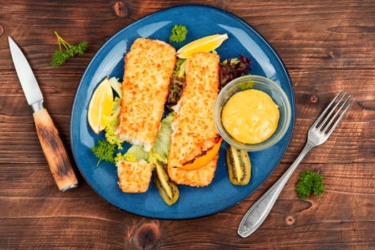 Pollock fillet roasted in bread crumbs and with kiwi. Fish. Space for text.