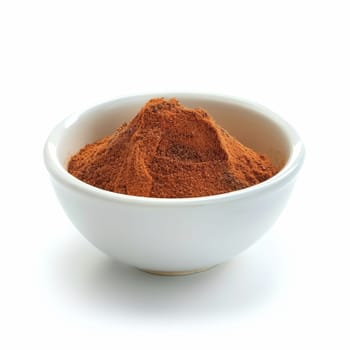 Close-up of ground cinnamon in a white bowl, isolated on a white background