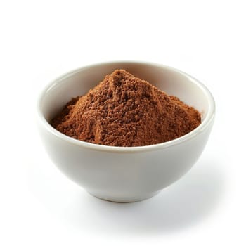 Close-up of ground cinnamon in a white bowl, isolated on a white background