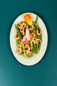 Delicious boiled shrimp with green asparagus. Ready to eat. Space for text.