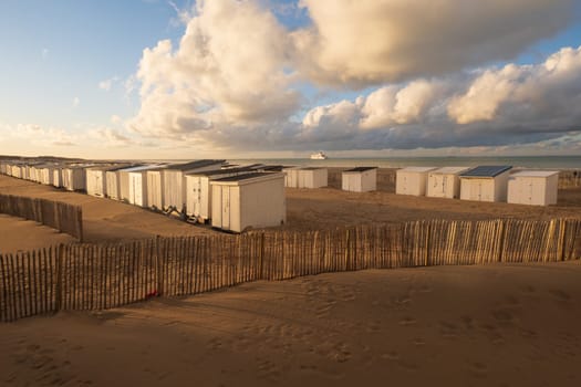 Landscape of the coast and harbor with cabins and the departure of a ferry in Calais, photographed in north of France