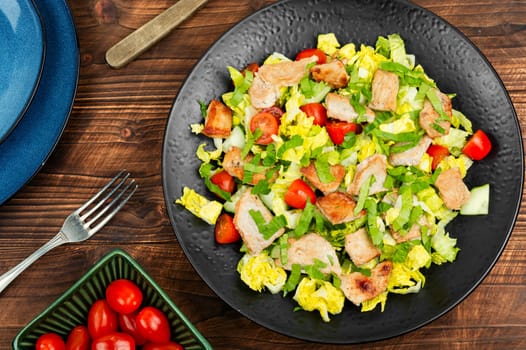 Fresh salad of fresh vegetables, herbs and fried meat. Dish. Roast. Lunch. Salad.