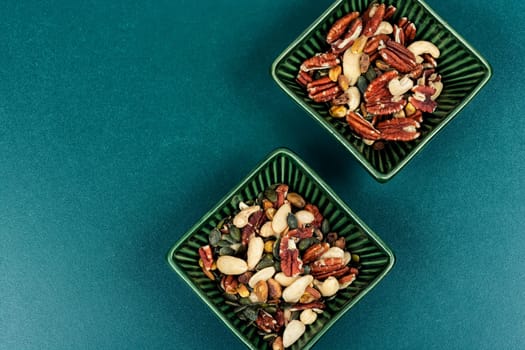 Large assortment of peeled nuts in bowl on a vintage wooden background. Superfood.