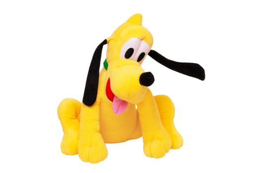 Plush toy dog isolated. Childrens toy stuffed animals. Close up of a playful yellow funny cute sitting toy plush toy dog on white background. Kids playing.