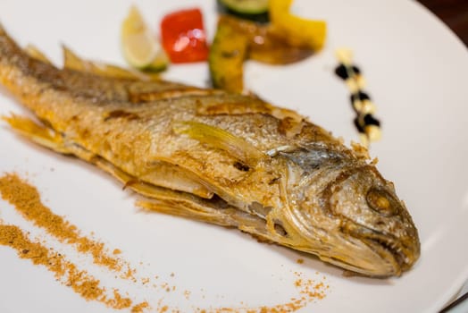 Grill fish on the white plate