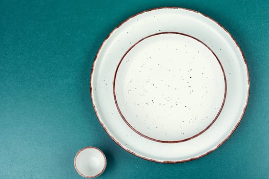 Empty ceramic plates on the kitchen table. Card or menu template. Tableware, crockery. Copy space.