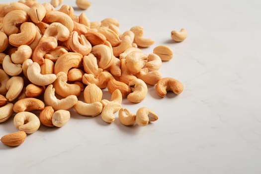 Cashew nuts scattered on a marble surface