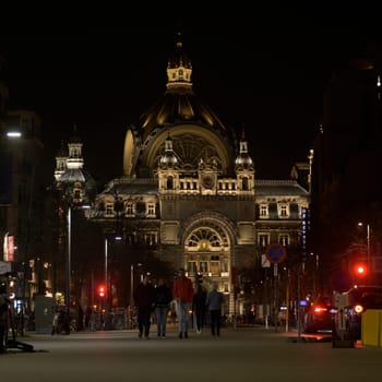 Antwerp, Belgium, March 21st 2024: Night view on De Keyserlei in Antwerp with NMBS Central Railway station.