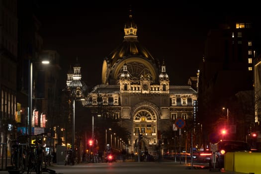 Antwerp, Belgium, March 21st 2024: Night view on De Keyserlei in Antwerp with NMBS Central Railway station.