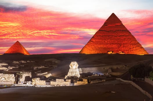 Illuminated Pyramids of Egypt and the great Sphinx night view, Giza.