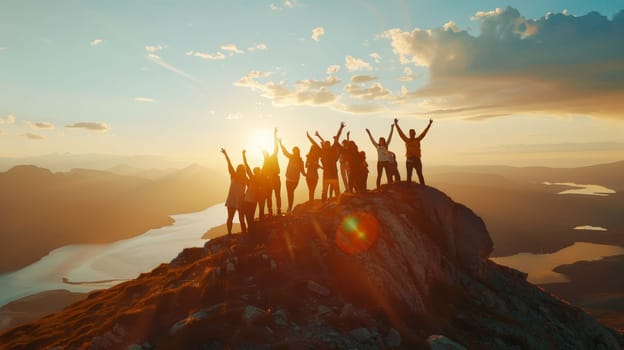 Experience the exhilarating moment as a large group of individuals revel in their triumph at the mountain peak, arms raised high in joyous celebration against a breathtaking backdrop of lakes and mountains illuminated by the setting sun.