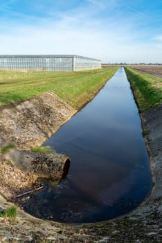 small ditch for water supply around a commercial greenhouse