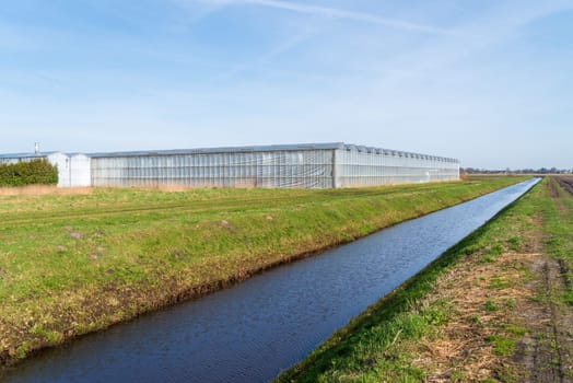 small ditch for water supply around a commercial greenhouse