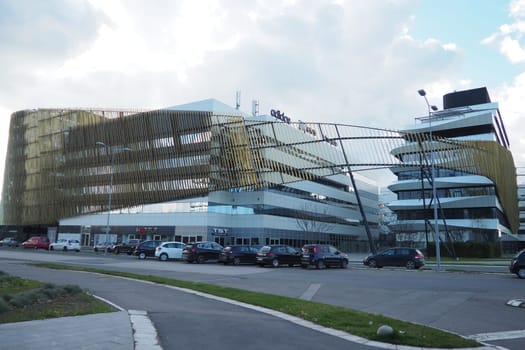 Belgrade, Serbia, 03.17.24: Nordeus smart ecological building. Milutin Milankovic Boulevard. Modern fashionable architecture with green initiatives. A ship-shaped house with glass walls and terraces.
