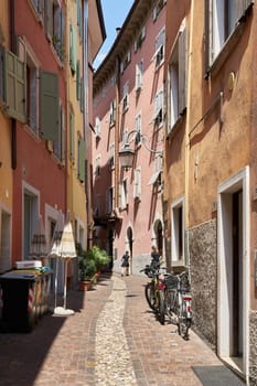 Narrow alley in the popular historic old town of Riva del Garda on Lake Garda in Italy