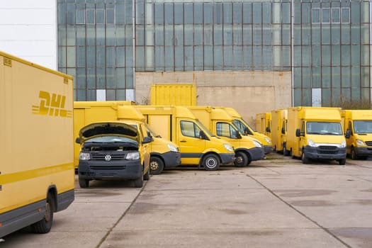 Discarded DHL vehicles that are no longer roadworthy in the yard of a car recycler in Magdeburg, Germany