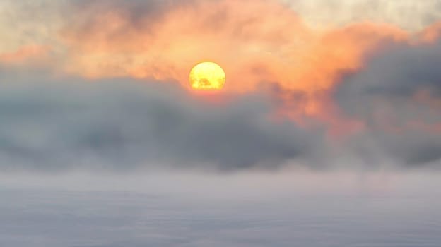Captured amidst a mystical mist, this ethereal photograph portrays the serene beauty of a sunset shrouded in fog, evoking a sense of mystery and tranquility.